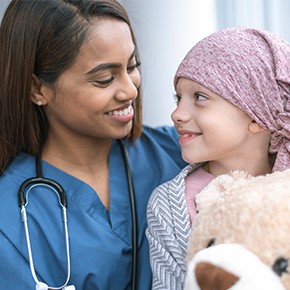 nurse consoles young cancer patient