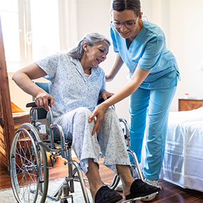 nurse helping older patient in wheelchair