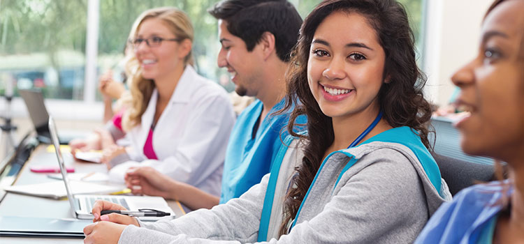 nursing students taking notes in classroom