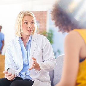 woman medical professional talking to female patient