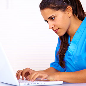 woman nurse typing on laptop