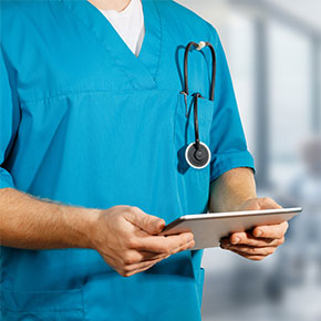 male nurse with stethoscope holds ipad