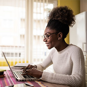 young woman typing on laptop