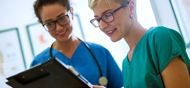 two nurses looking at chart