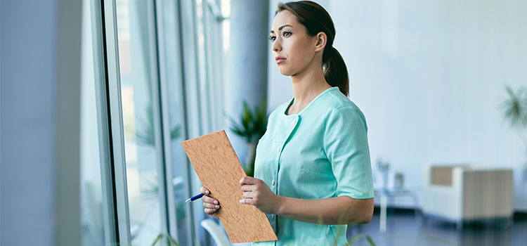 dermatology nurse looking out window at medical facility