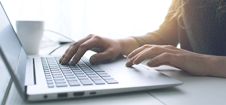 closeup of woman working at laptop computer