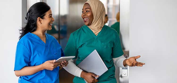 two nurse walking through hospital talking