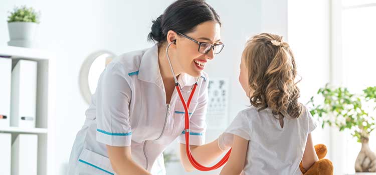 nursing using stethoscope on young patient