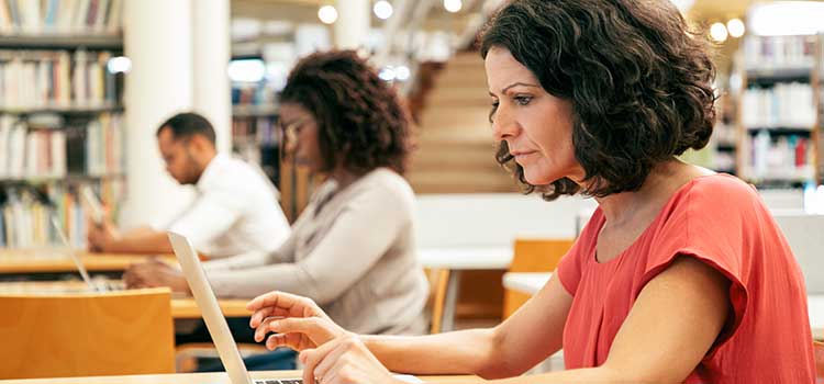 woman researching online in library