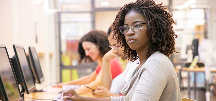 woman looks at laptop screen