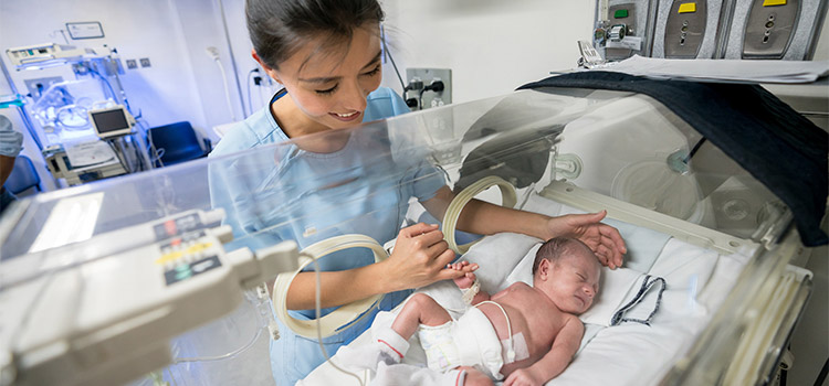 neonatal nurse with newborn baby