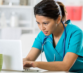 nurse working on laptop computer