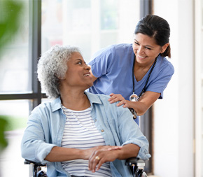 nurse shares a laugh with adult patient