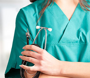 closeup of nurse holding stethoscope with arms crossed