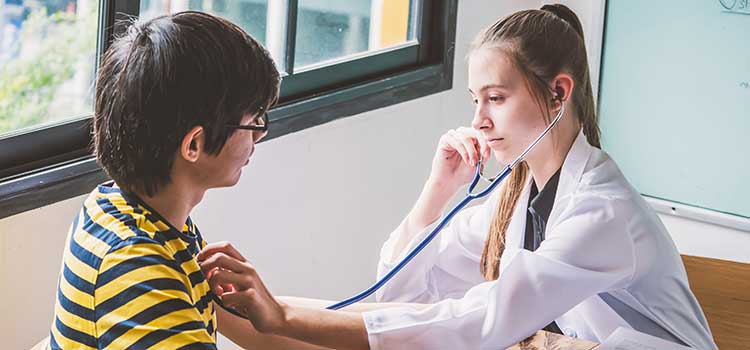 female nurse volunteering giving heart check exam