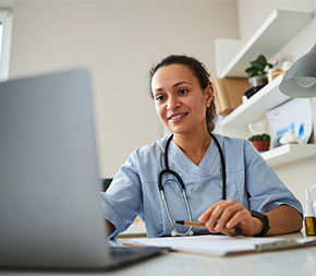 nurse studying on laptop computer