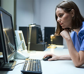 nurse working on desktop computer
