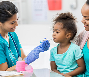 nurse takes child patient temperature