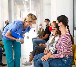 public health nurse greeting girl patient in hallways