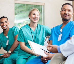 three nurses in meeting with manager