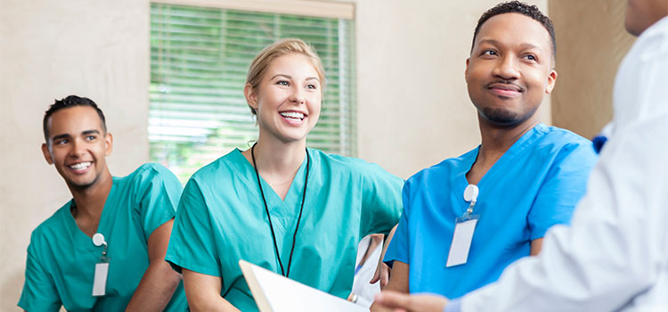 three nurses in meeting with manager