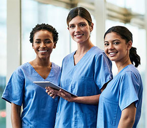 three smiling nurses in healthcare facility
