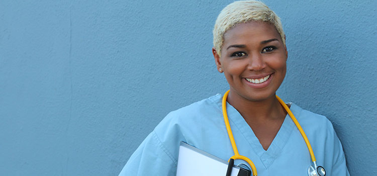 smiling nurse holding folder and pen