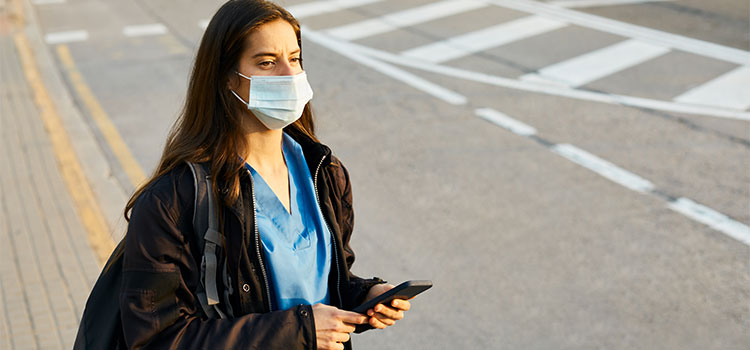 nurse standing near helicopter landing strip on medical facility rooftop