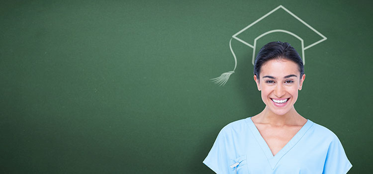 nurse standing in front of chalkboard with mortarboard drawing on head