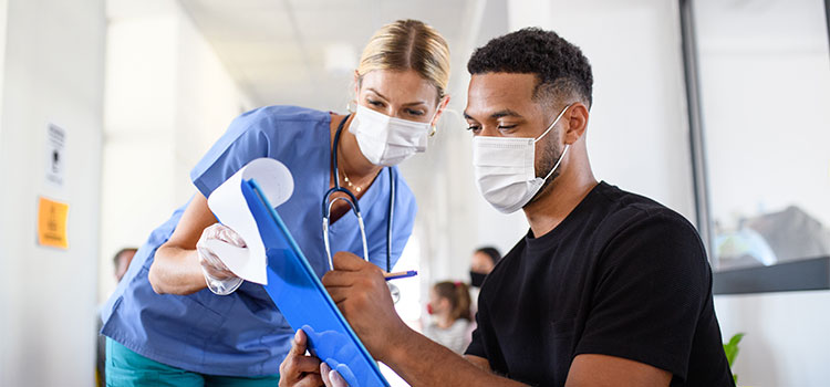 nurse helping patient with paperwork