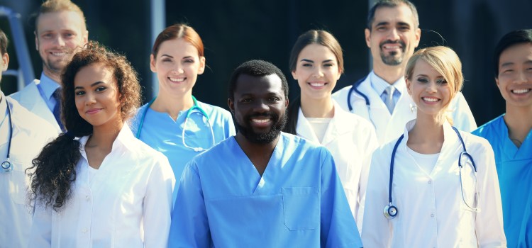 group of nurses smiling and posing for the camera