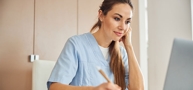 woman doing research on laptop
