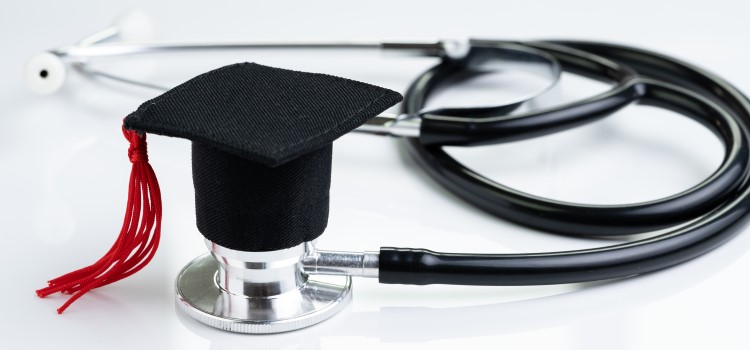 photo of graduation cap posed on top of a stethoscope