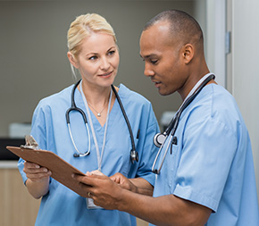 two nurses conferring over chart