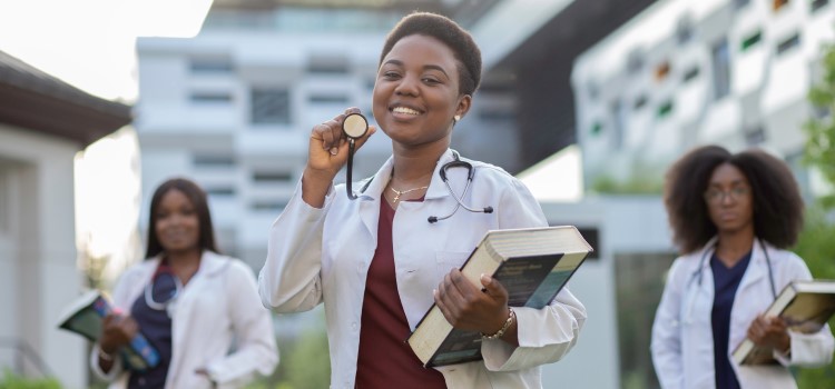 Three female nurses pitcture, center is posing with stethascope