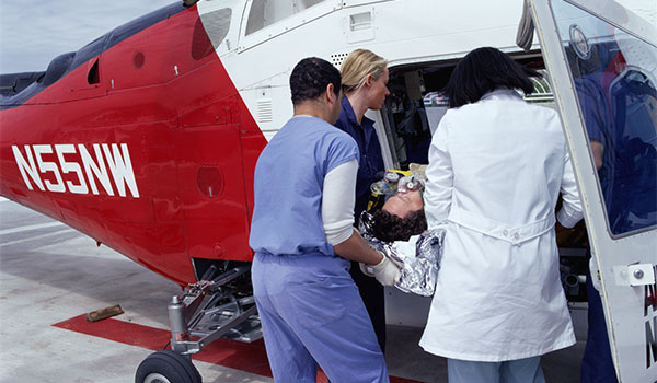 flight nurses loading emergency situation patient into plane