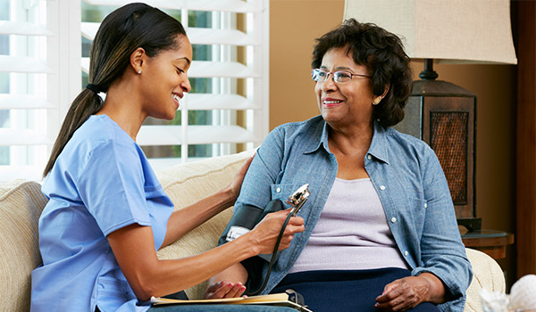 hime health nurse takes elderly womans blood pressure