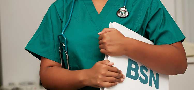 female nurse holds folder tightly that says BSN