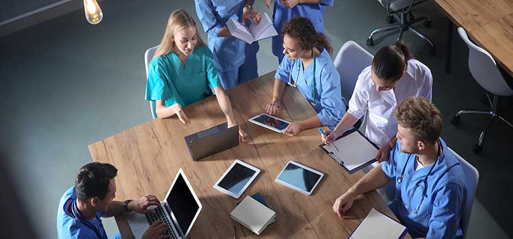 nurses working together on tablets