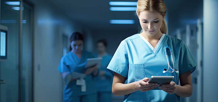 nurse practitioner walks down darkened hospital corridor on night rounds