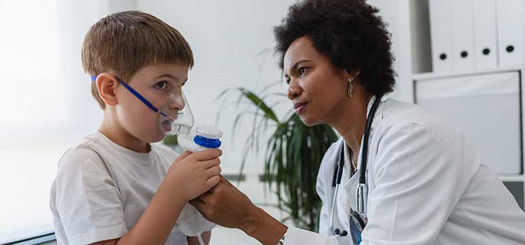 respiratory nurse works with young patient