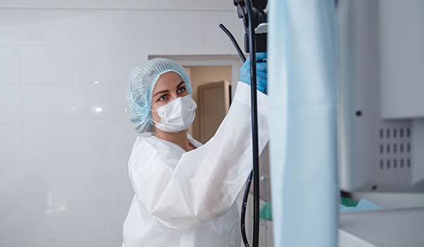 endoscopy nurse prepares equipment for procedure