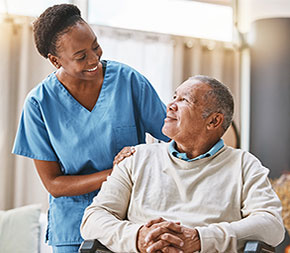 entry level nurse graduate assists elderly patient in hospital room