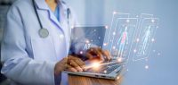 nurse projects patient vitals using AI on laptop